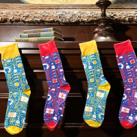 Four GitHub-branded socks in alternating colors hanging from a wooden mantel, like Christmas stockings.